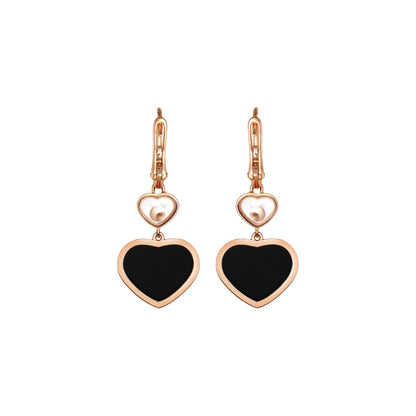 Chopard Happy Hearts earrings in 18k ethical rose gold with moving diamonds and onyx view 4